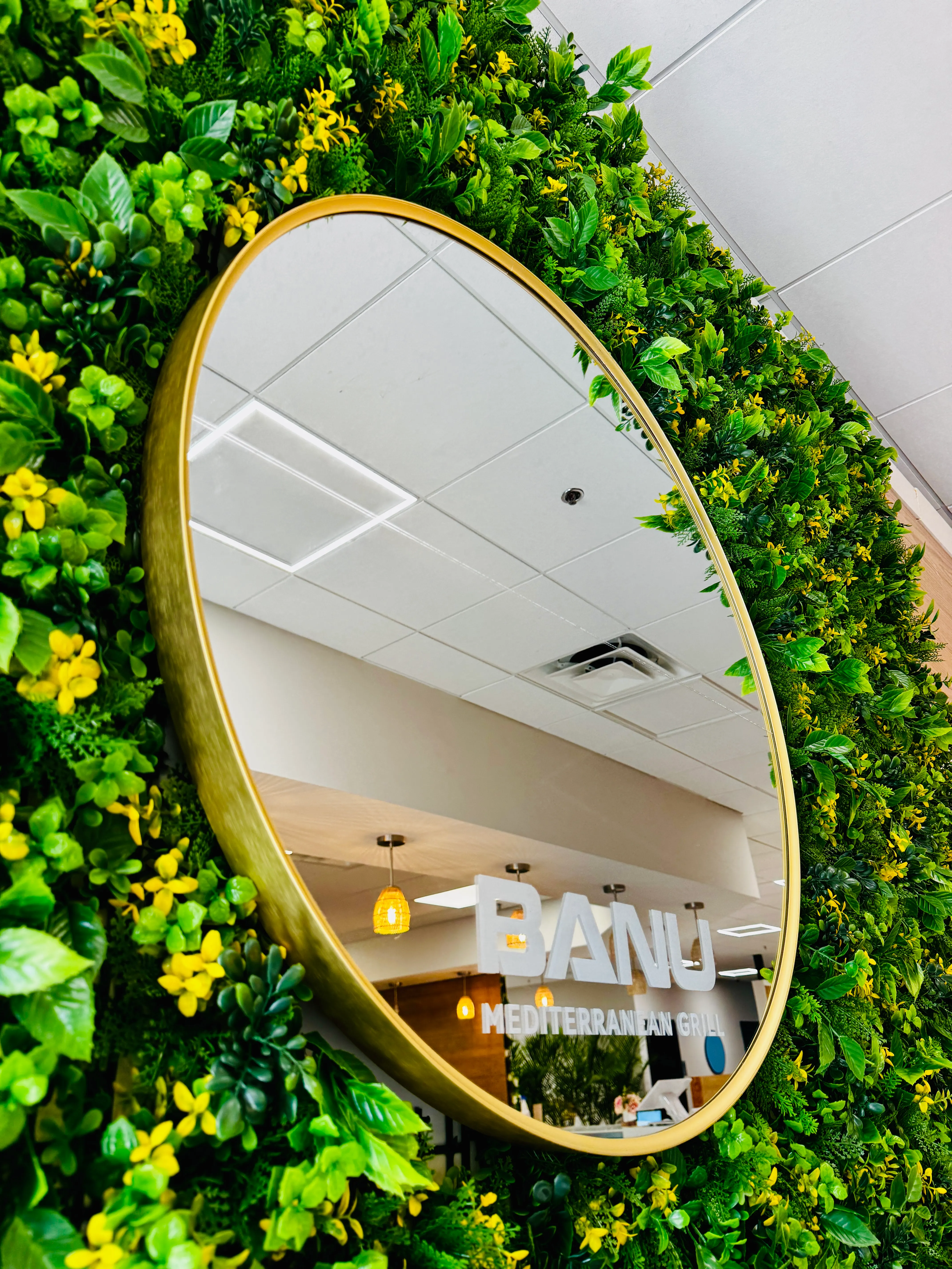 Banu interior with green living wall and gold mirror